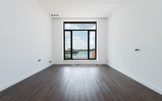 Free Interior of modern spacious light room with wooden laminate floor white walls and panoramic windows Stock Photo